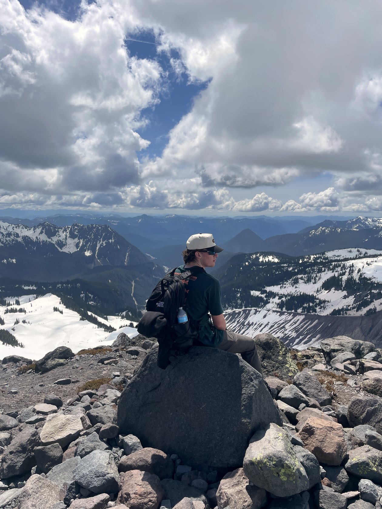 Treyson sitting above the valley on Mount Rainier